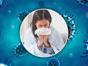 persona che si soffia il naso e dietro un virus