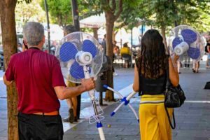 un uomo e una donna con un ventilatore in mano