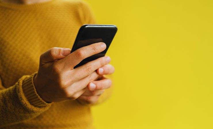 uomo tiene in mano smartphone