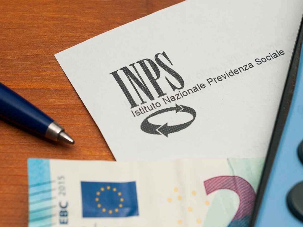 foglio di carta intestata INPS con vicino una penna e una banconota