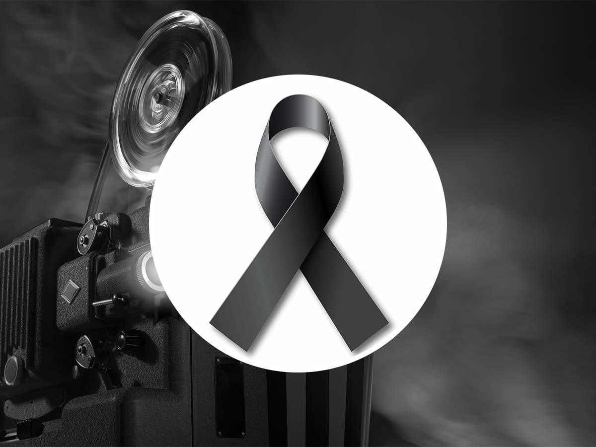 simbolo lutto con dietro una cinepresa